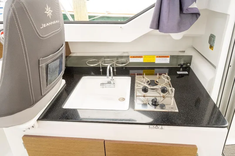 Slide: The Image of Compact kitchen area in a 2021 Jeanneau NC Weekender 795 Series 2 boat. - 20