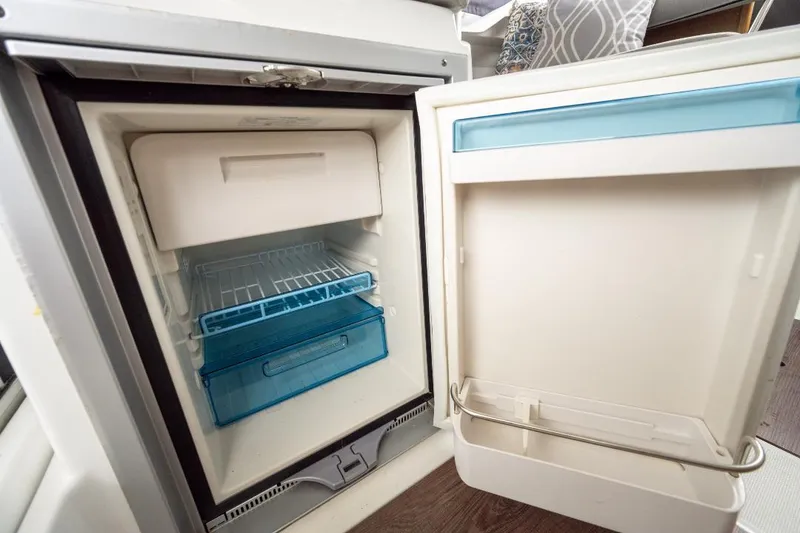 Slide: The Image of Open refrigerator inside Jeanneau NC Weekender 795 Series 2 boat, 2021 model. - 26