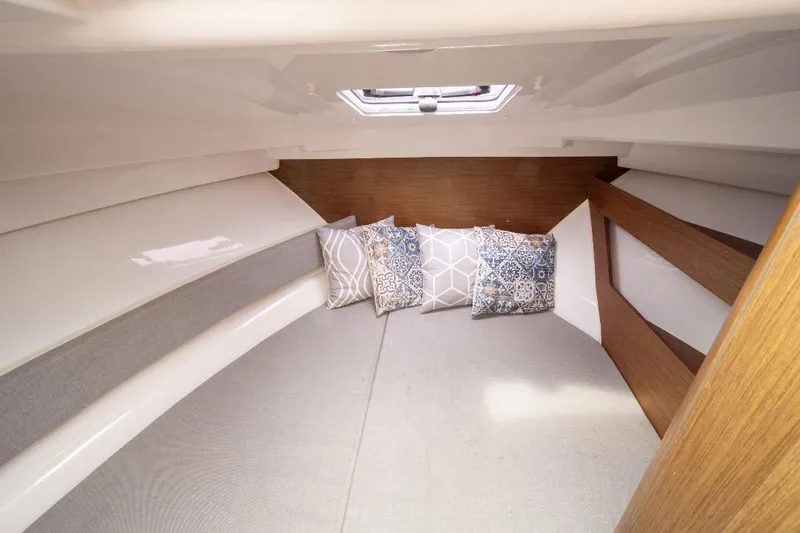 Slide: The Image of Cozy cabin interior of 2021 Jeanneau NC Weekender 795 Series 2 with decorative pillows. - 28