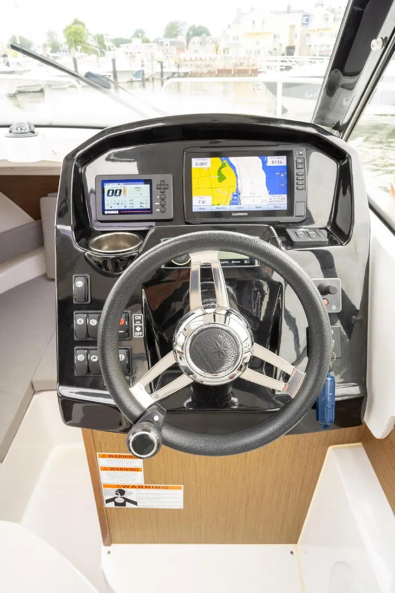 Slide: The Image of 2021 Jeanneau NC Weekender 795 Series 2 helm with navigation displays and steering wheel. - 30