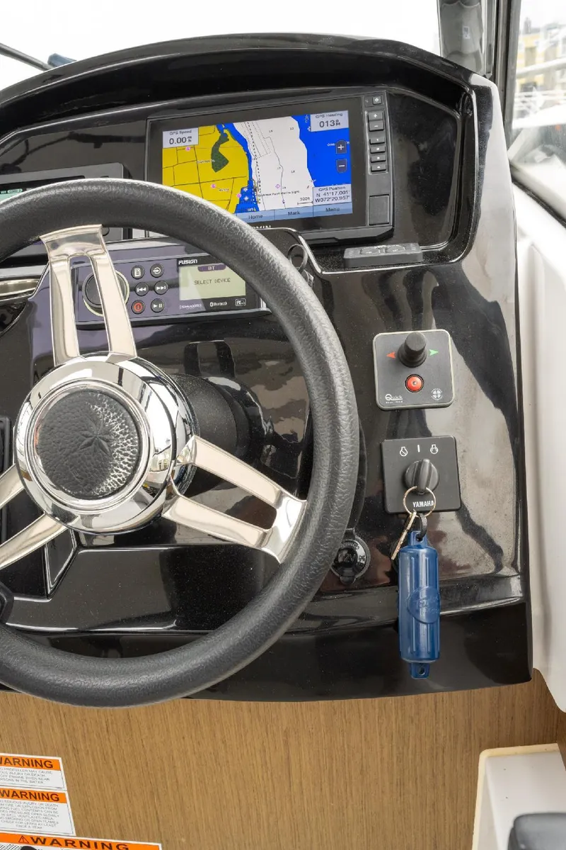 Slide: The Image of Steering wheel and navigation system of 2021 Jeanneau NC Weekender 795 Series 2 boat. - 34