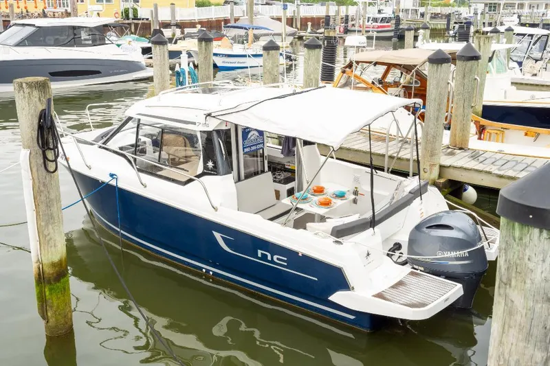 Slide: The Image of 2021 Jeanneau NC Weekender 795 Series 2 docked at marina with Yamaha outboard. - 4