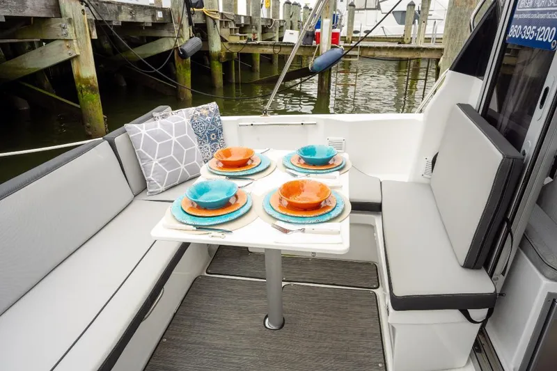 Slide: The Image of Cozy dining setup on Jeanneau NC Weekender 795 Series 2 boat, docked at marina. - 9