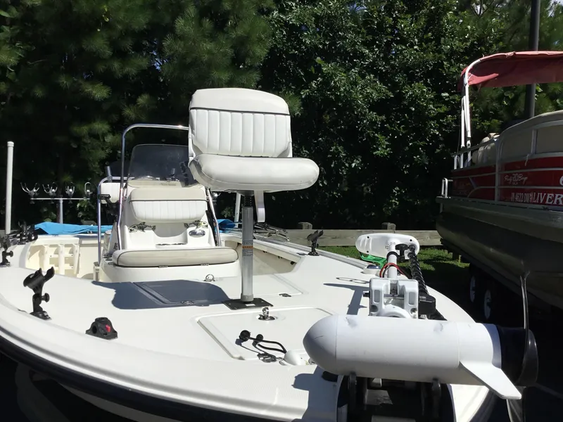 Slide: The Image of 2015 Mako 18 LTS boat with seating and equipment, surrounded by trees. - 3