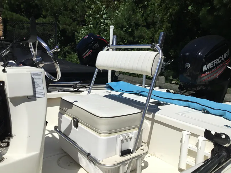 Slide: The Image of 2015 Mako 18 LTS boat interior with Mercury outboard motor and cushioned seating. - 5