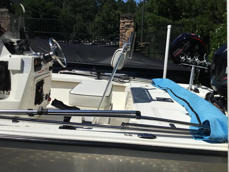 Slide: The Image of 2015 Mako 18 LTS boat interior with steering wheel and seating, outdoors. - 6