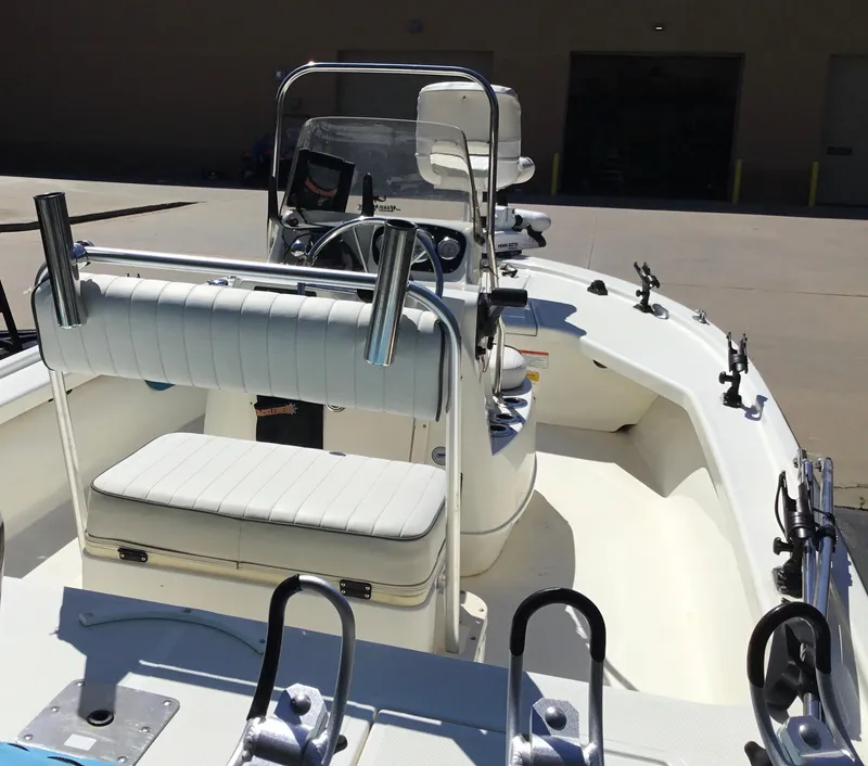 Slide: The Image of 2015 Mako 18 LTS boat interior with seating and fishing rod holders. - 8