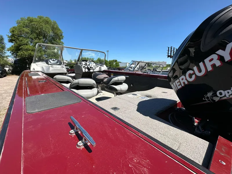 Slide: The Image of 2011 Tracker Targa V-18 Combo boat with Mercury engine, red exterior, and spacious seating. - 10