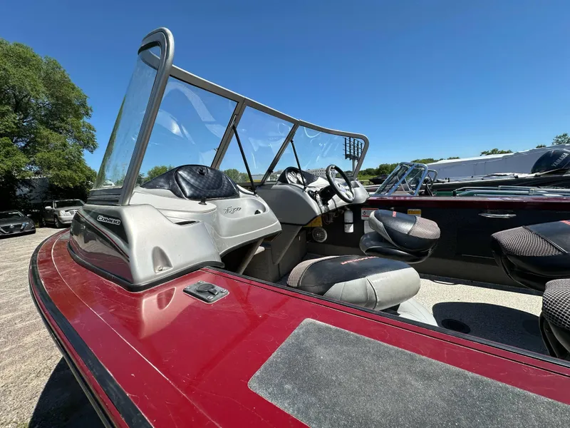 Slide: The Image of 2011 Tracker Targa V-18 Combo boat with red exterior and spacious seating. - 11