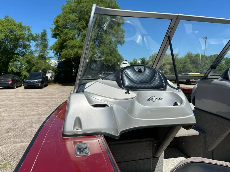 Slide: The Image of 2011 Tracker Targa V-18 Combo boat with windshield, parked outdoors on a sunny day. - 14