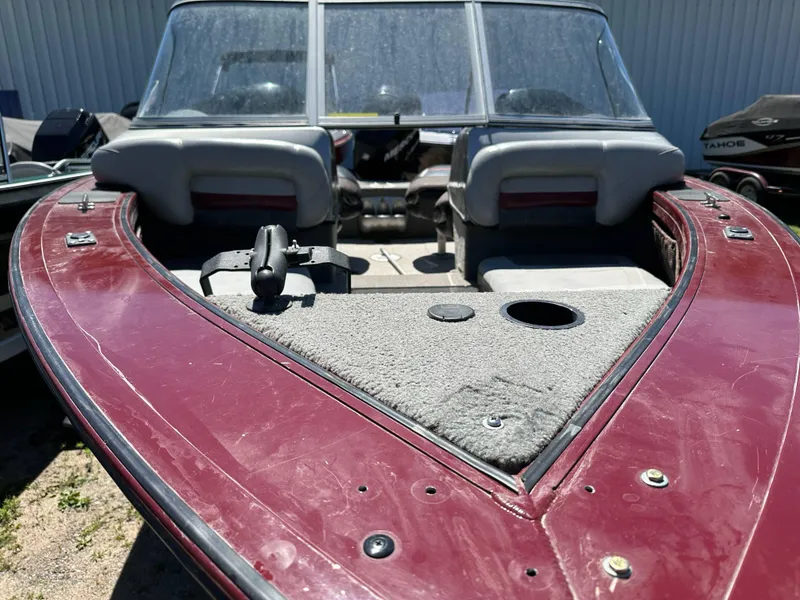 Slide: The Image of 2011 Tracker Targa V-18 Combo boat with maroon deck and seating. - 18