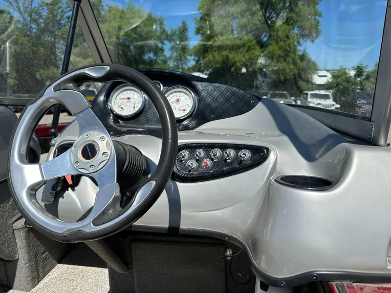 Slide: The Image of 2011 Tracker Targa V-18 Combo boat dashboard with steering wheel and gauges. - 19