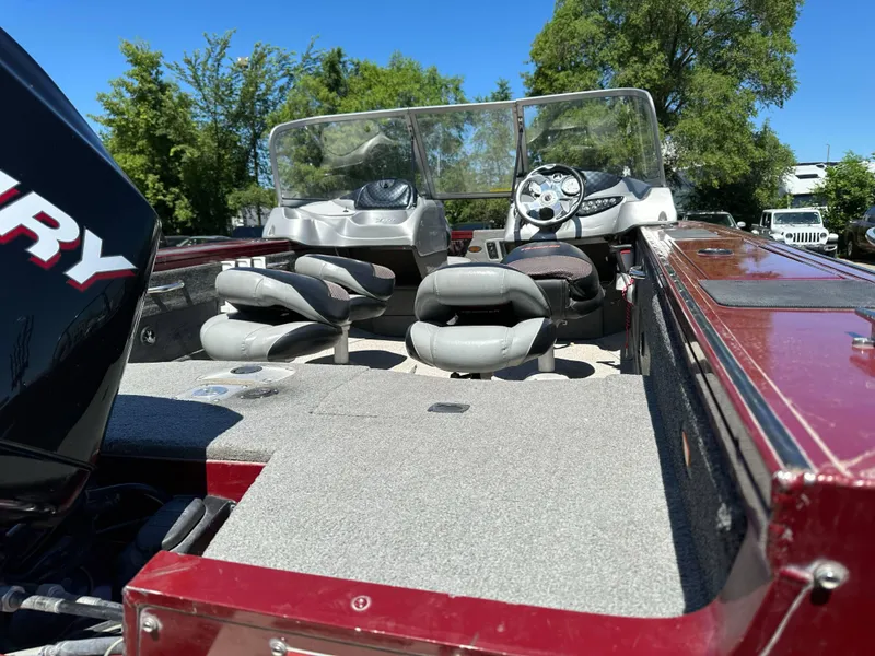 Slide: The Image of 2011 Tracker Targa V-18 Combo boat interior with seats and steering wheel, under clear blue sky. - 4