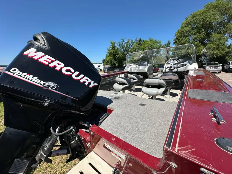 Slide: The Image of 2011 Tracker Targa V-18 Combo boat with Mercury OptiMax engine, parked outdoors. - 5