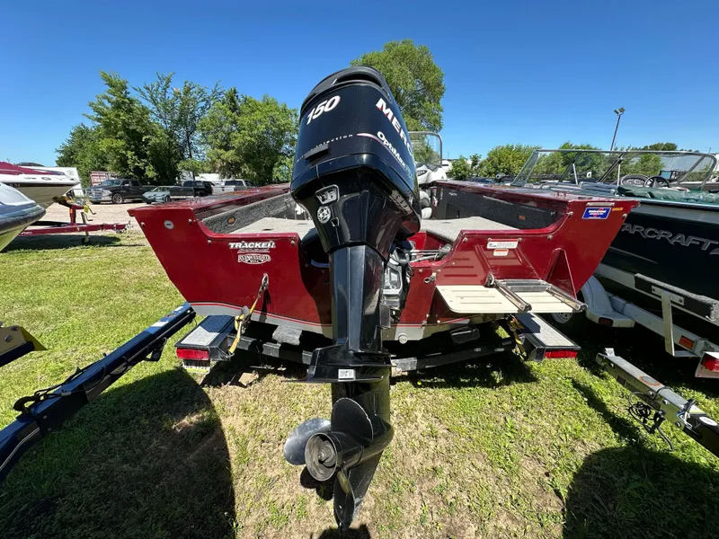 Slide: The Image of 2011 Tracker Targa V-18 Combo boat with Mercury 150 outboard motor on grassy lot. - 6