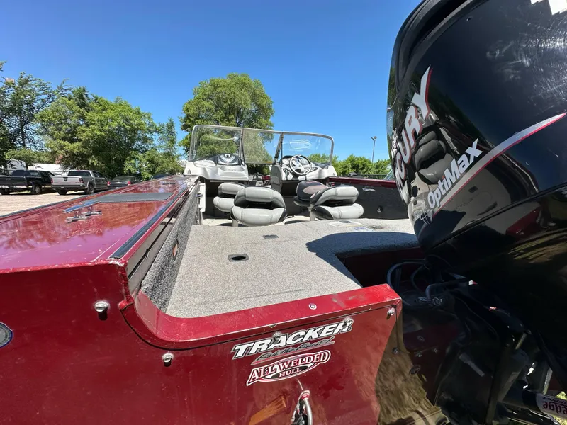 Slide: The Image of 2011 Tracker Targa V-18 Combo boat with Mercury OptiMax engine, parked outdoors. - 7