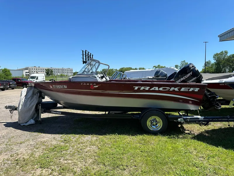 Slide: The Image of 2011 Tracker Targa V-18 Combo boat on trailer, parked outdoors on grass. - 8