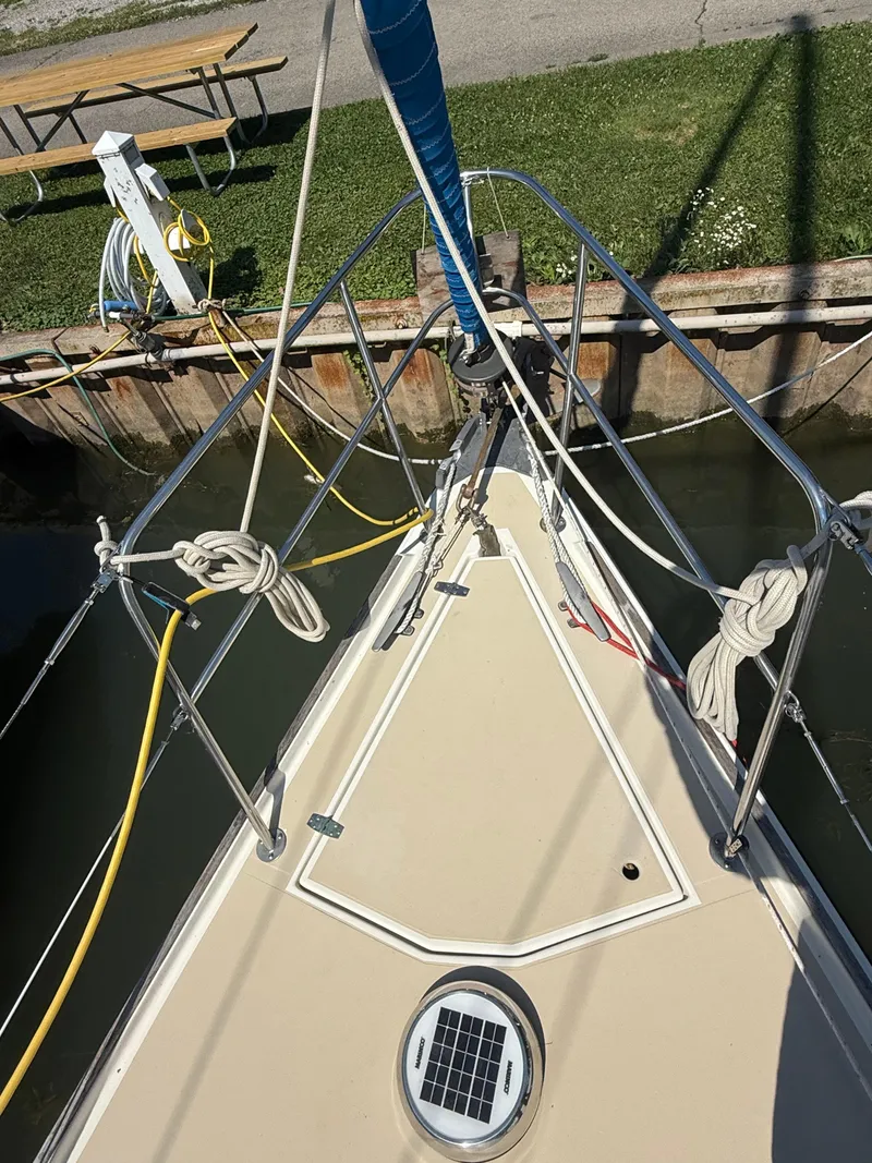 Slide: The Image of Bow of 1982 O'Day 34 sailboat docked, showing deck and rigging. - 10