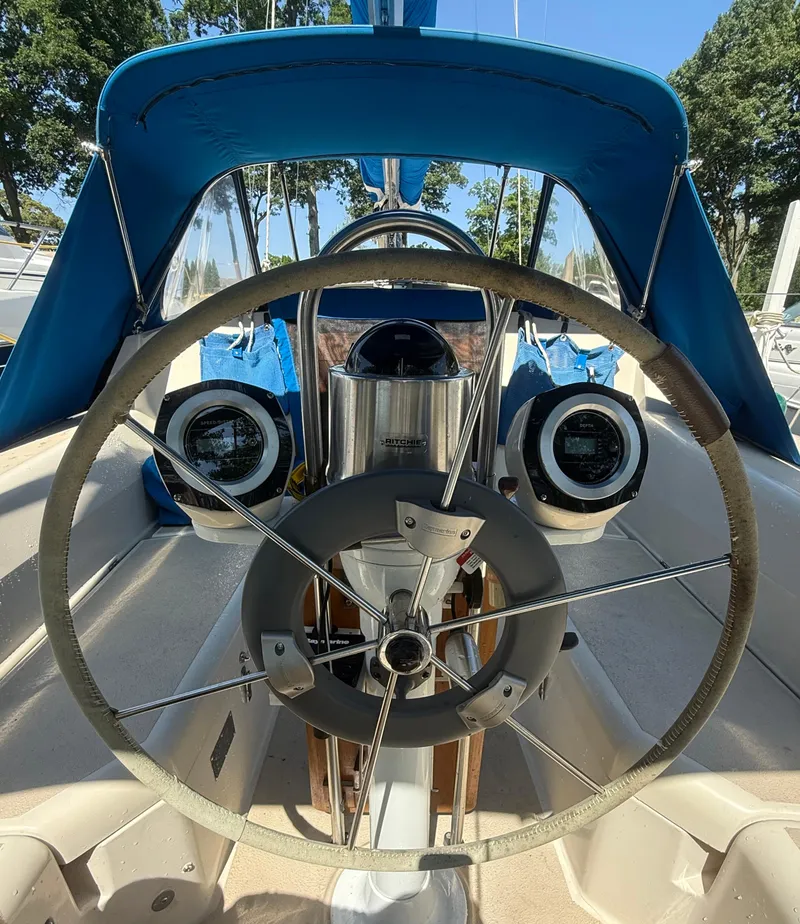 Slide: The Image of 1982 O'Day 34 sailboat cockpit with steering wheel and blue canopy. - 14