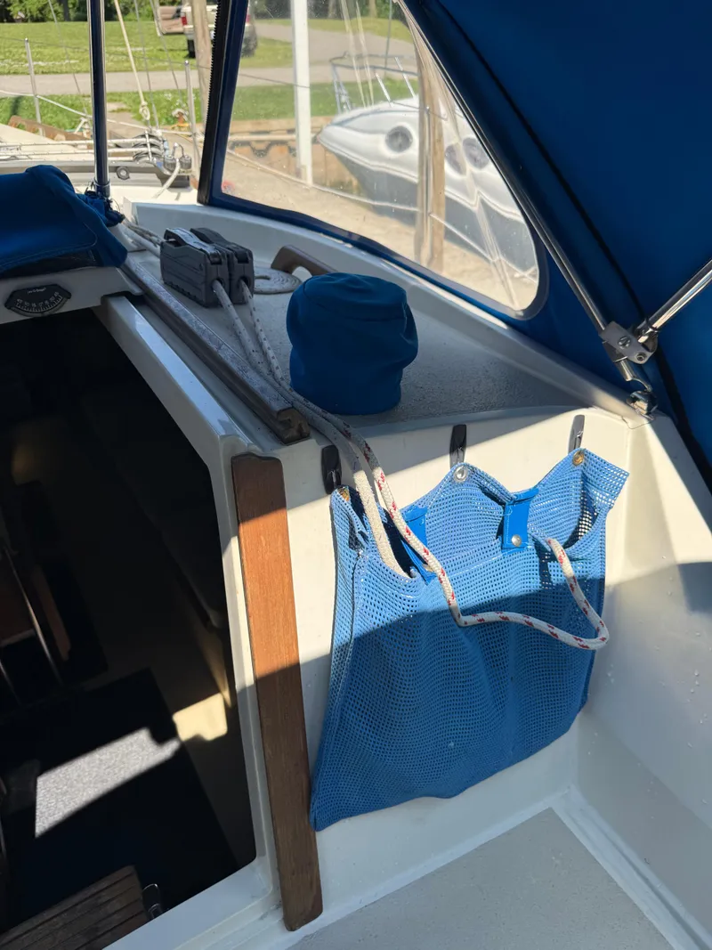 Slide: The Image of 1982 O'Day 34 sailboat cockpit with blue mesh storage and ropes. - 17