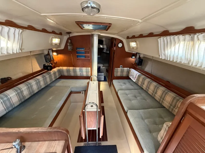 Slide: The Image of Interior of 1982 O'Day 34 sailboat with cozy seating and wooden accents. - 19