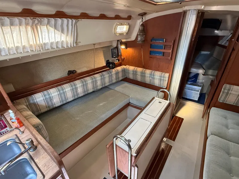 Slide: The Image of Interior of 1982 O'Day 34 sailboat with cozy seating and wooden accents. - 20