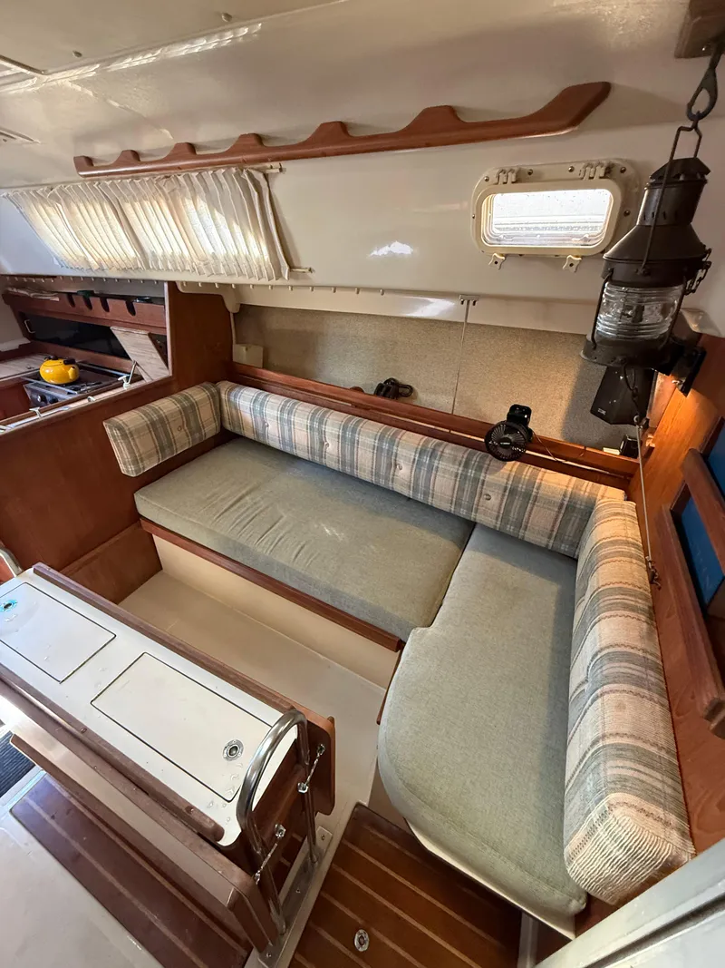 Slide: The Image of Interior of 1982 O'Day 34 sailboat with cozy seating and wooden accents. - 21