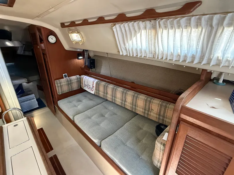 Slide: The Image of Interior of 1982 O'Day 34 sailboat with plaid seating and wooden accents. - 22