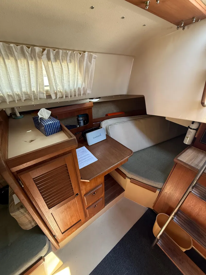 Slide: The Image of Interior of 1982 O'Day 34 sailboat with wooden cabinetry and seating area. - 23