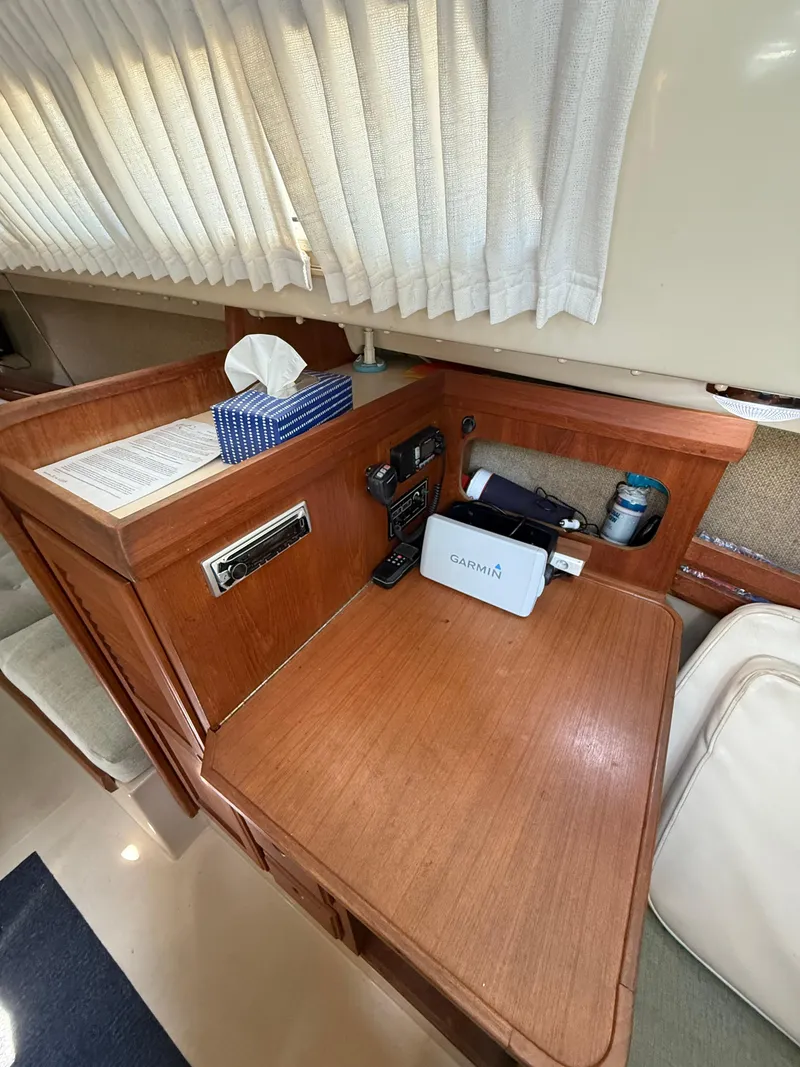 Slide: The Image of 1982 O'Day 34 sailboat interior with navigation station and wooden desk. - 24