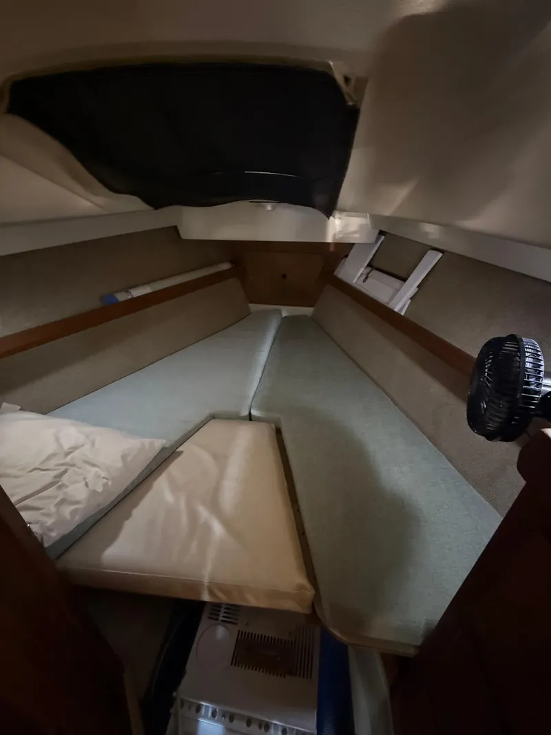 Slide: The Image of Interior cabin of a 1982 O'Day 34 sailboat, featuring a cozy sleeping area. - 28