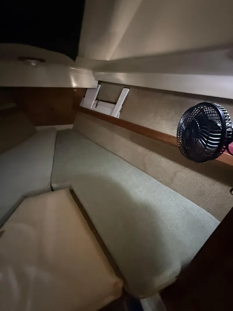 Slide: The Image of Interior cabin of a 1982 O'Day 34 sailboat with seating and a small fan. - 29