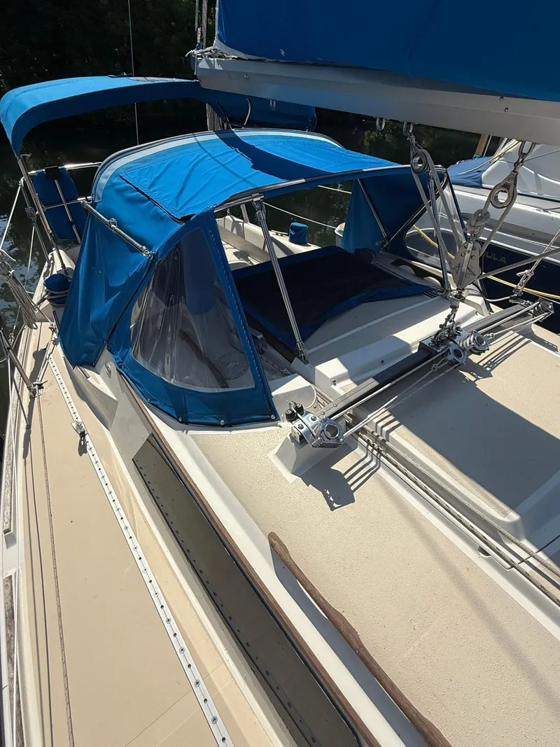 Slide: The Image of 1982 O'Day 34 sailboat with blue canvas covers and rigging details. - 3