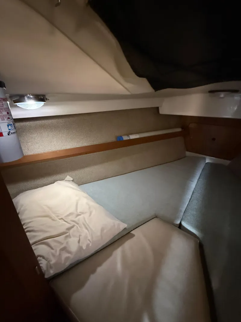 Slide: The Image of Cozy cabin interior of 1982 O'Day 34 sailboat with bedding and soft lighting. - 30