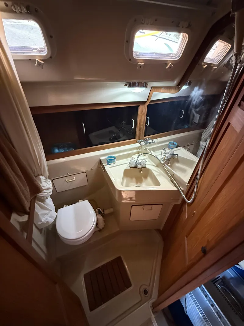 Slide: The Image of Compact bathroom in 1982 O'Day 34 sailboat with sink, toilet, and mirror. - 31