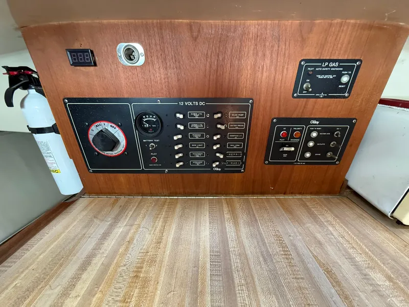 Slide: The Image of Control panel of a 1982 O'Day 34 sailboat with switches and fire extinguisher. - 32