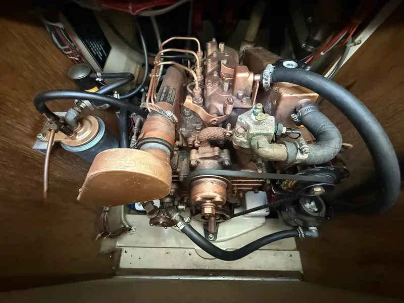 Slide: The Image of Engine compartment of a 1982 O'Day 34 sailboat, showing detailed mechanical components. - 33