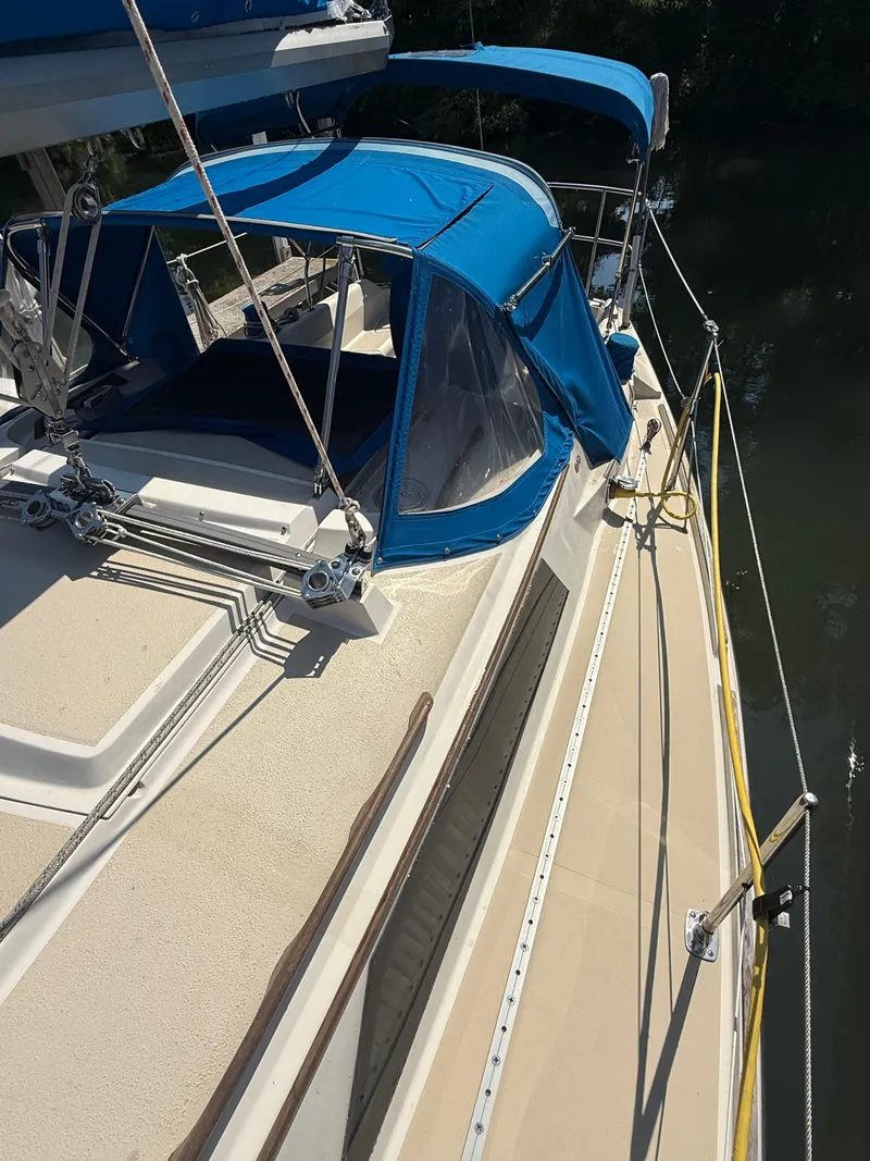 Slide: The Image of 1982 O'Day 34 sailboat with blue canopy and deck details. - 4