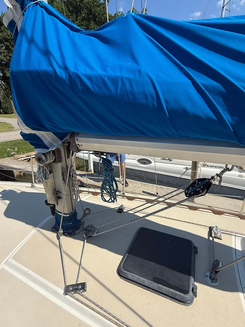 Slide: The Image of 1982 O'Day 34 sailboat deck with blue sail cover and rigging. - 6