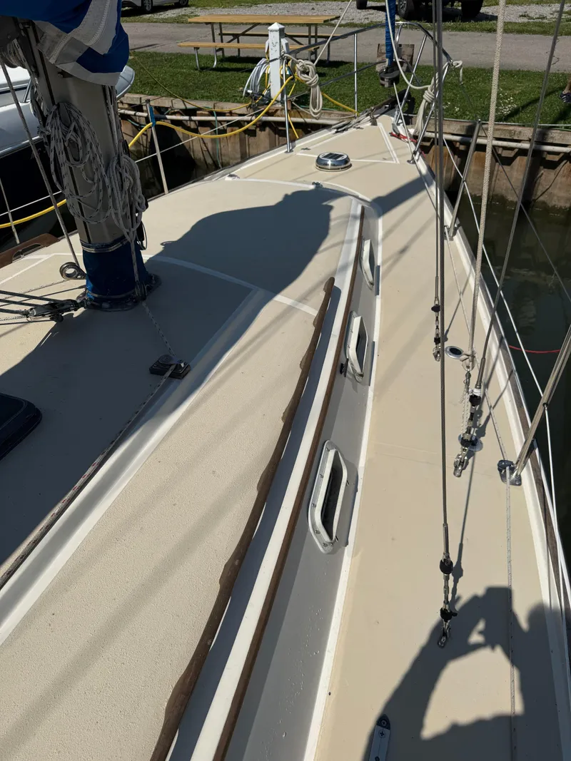 Slide: The Image of 1982 O'Day 34 sailboat deck with rigging and shadow, docked at marina. - 7