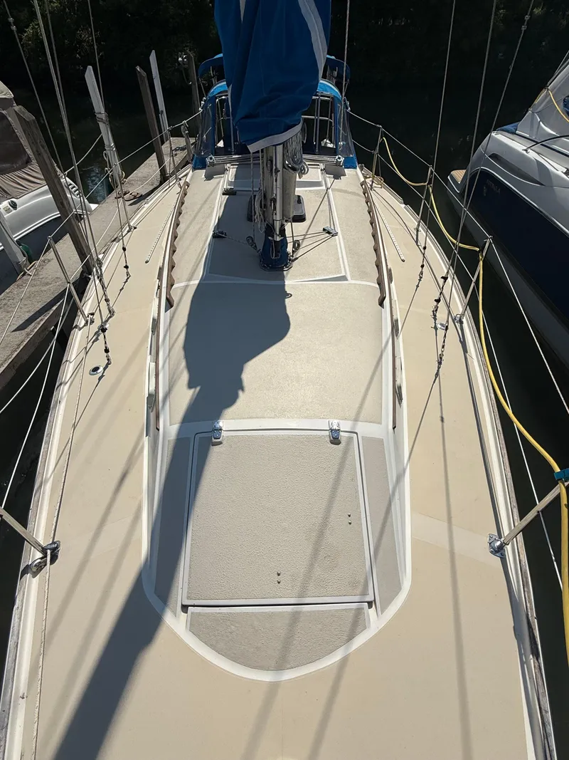 Slide: The Image of 1982 O'Day 34 sailboat deck with rigging and covered mast. - 8