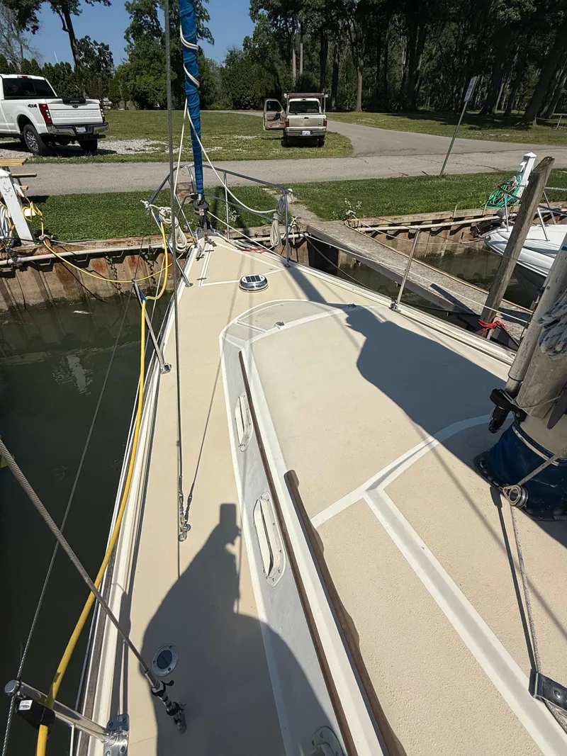 Slide: The Image of 1982 O'Day 34 sailboat docked, showing deck and rigging under clear sky. - 9
