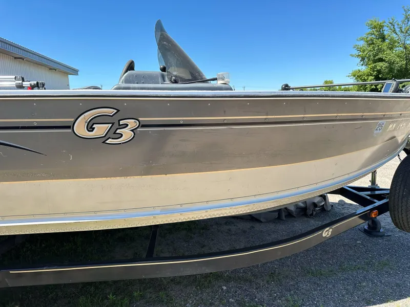 Slide: The Image of 2005 G3 1875 boat on trailer, side view with clear sky background. - 10