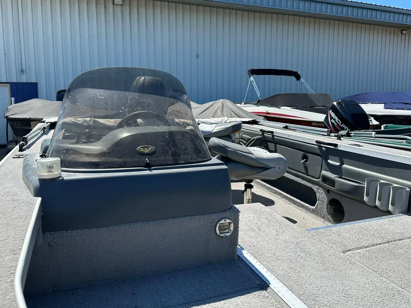 Slide: The Image of 2005 G3 1875 boat with windshield and seating, parked outdoors. - 12