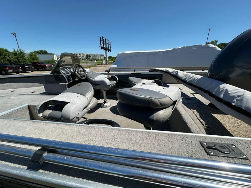 Slide: The Image of 2005 G3 1875 boat interior with seating and steering wheel under clear blue sky. - 16