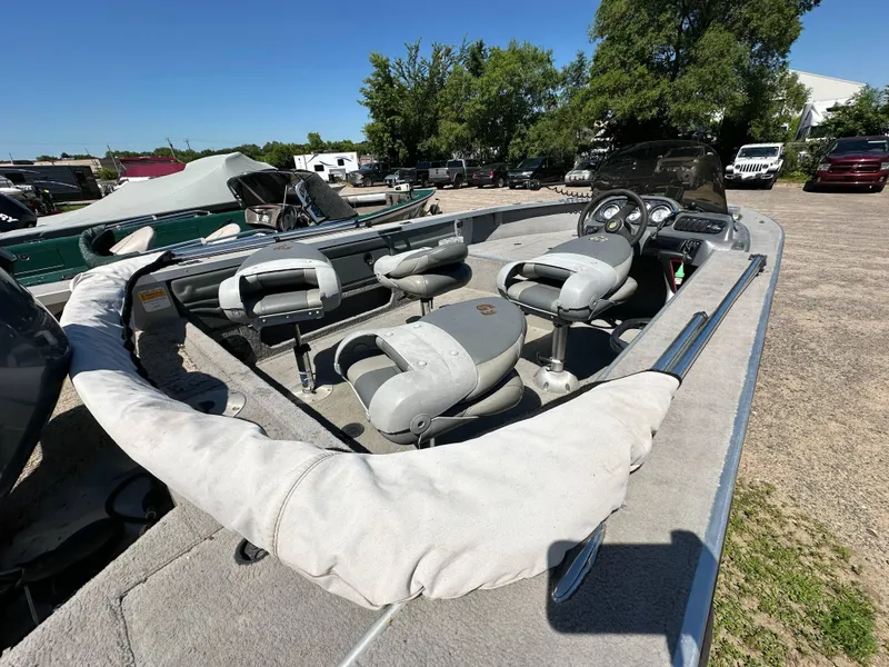 Slide: The Image of 2005 G3 1875 boat interior with seating and steering console in outdoor setting. - 22