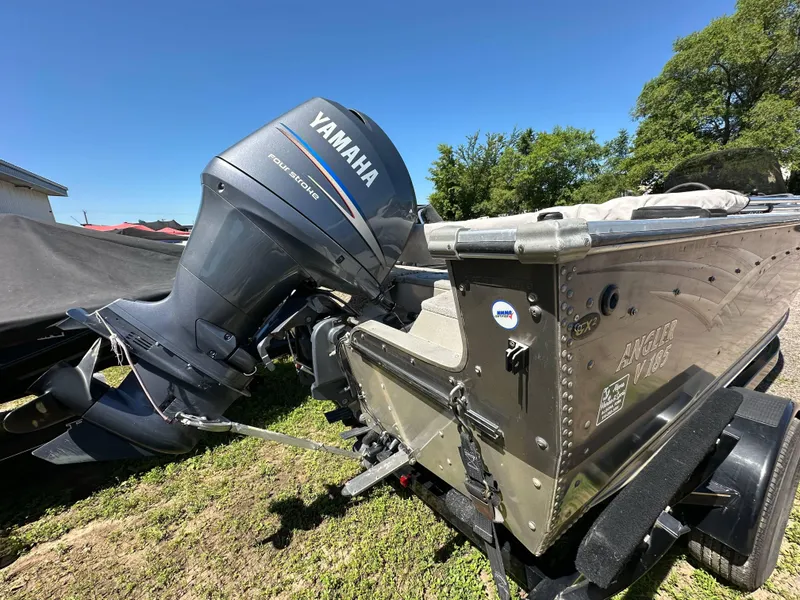 Slide: The Image of 2005 G3 1875 boat with Yamaha four-stroke engine, parked on grass. - 23