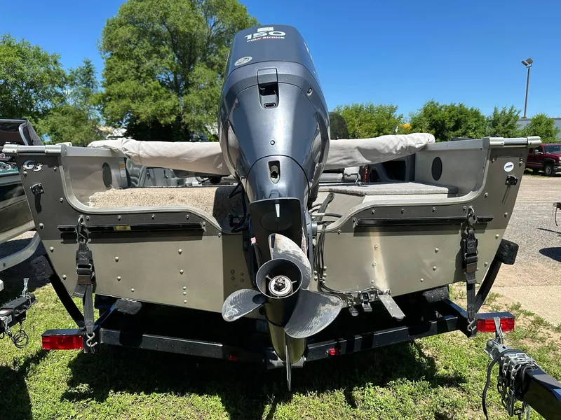 Slide: The Image of 2005 G3 1875 boat with outboard motor on trailer, parked outdoors. - 26