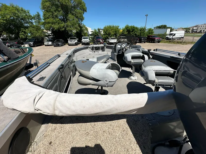 Slide: The Image of 2005 G3 1875 boat interior with seating and steering wheel, parked outdoors. - 27