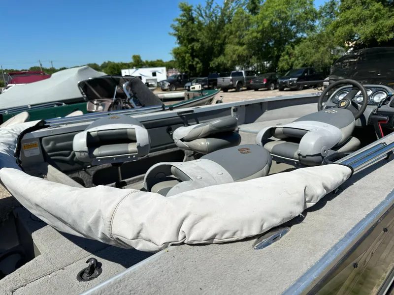 Slide: The Image of 2005 G3 1875 boat interior with gray seating and steering wheel, parked outdoors. - 9